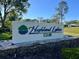 Attractive Highland Lakes community entrance sign with stone base and manicured landscaping at 3224 Hilary Cir, Palm Harbor, FL 34684