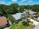 Beautiful home with manicured lawn and garden, complemented by a gray shingle roof at 3224 Hilary Cir, Palm Harbor, FL 34684