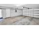 Spacious two car garage with white walls and an automatic door opener at 3224 Hilary Cir, Palm Harbor, FL 34684