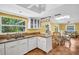 Bright kitchen with white cabinets, tiled floor, and modern appliances at 3224 Hilary Cir, Palm Harbor, FL 34684