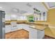 Kitchen with stainless steel appliances, granite countertops, tile floors and white cabinets at 3224 Hilary Cir, Palm Harbor, FL 34684