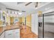 Open kitchen featuring modern appliances, tiled floors, and dining space at 3224 Hilary Cir, Palm Harbor, FL 34684