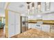 Kitchen with stainless steel appliances, granite countertops and ample white cabinets at 3224 Hilary Cir, Palm Harbor, FL 34684