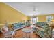 Spacious living room featuring tiled floors and tropical furniture at 3224 Hilary Cir, Palm Harbor, FL 34684
