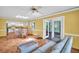 Inviting living room with tile floors, skylight, ceiling fan and sliding doors to a screened lanai at 3224 Hilary Cir, Palm Harbor, FL 34684