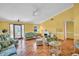 Bright living room features tropical themed furniture and a cozy fireplace at 3224 Hilary Cir, Palm Harbor, FL 34684