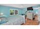 Bedroom featuring two windows, tile floors, a ceiling fan, a TV and mirrored closets at 3224 Hilary Cir, Palm Harbor, FL 34684