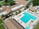 Aerial view of a community pool with lounge chairs and patio furniture at 3224 Hilary Cir, Palm Harbor, FL 34684