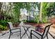 Inviting backyard patio with outdoor seating, nestled among mature trees, enhancing privacy and creating a relaxing ambiance at 3406 Hollyhock Way, Tampa, FL 33618