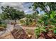 A beautiful backyard featuring landscaping and a patio area with an umbrella at 3406 Hollyhock Way, Tampa, FL 33618