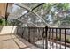 Screened balcony with beautiful architectural structure providing shade and a view of the yard below at 3406 Hollyhock Way, Tampa, FL 33618