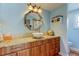 Bright bathroom featuring granite countertops, a modern vessel sink, and an octagonal mirror at 3406 Hollyhock Way, Tampa, FL 33618