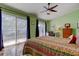 Bedroom showcases an open balcony, a bright atmosphere, and a large sliding glass door at 3406 Hollyhock Way, Tampa, FL 33618