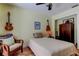Relaxing bedroom featuring a ceiling fan, guitar decor, and light-colored walls at 3406 Hollyhock Way, Tampa, FL 33618