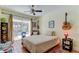 Cozy bedroom with a ceiling fan, decor, and sliding glass doors to the pool area at 3406 Hollyhock Way, Tampa, FL 33618