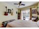 Comfortable bedroom with a view to the pool, ceiling fan, and stylish decor at 3406 Hollyhock Way, Tampa, FL 33618