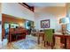 Open-concept dining room with tile floors, art, and piano at 3406 Hollyhock Way, Tampa, FL 33618