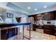 Stylish kitchen boasting stainless steel appliances, tile backsplash, and a breakfast bar at 3406 Hollyhock Way, Tampa, FL 33618