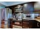 Modern kitchen boasts stainless steel appliances, sleek dark cabinetry, and stylish countertops at 3406 Hollyhock Way, Tampa, FL 33618