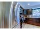 Well-lit kitchen features stainless steel appliances, dark cabinets, and a window with a view at 3406 Hollyhock Way, Tampa, FL 33618