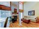 Open-concept living room featuring a stone fireplace, wood floors, and natural light at 3406 Hollyhock Way, Tampa, FL 33618