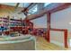 Charming living room featuring wood flooring, a ceiling fan, and book-lined walls at 3406 Hollyhock Way, Tampa, FL 33618