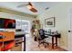 Bright office with natural light from sliding doors, tiled floors, and ceiling fan at 3406 Hollyhock Way, Tampa, FL 33618