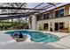 Beautiful pool with decorative stonework and screened enclosure, offering great views from the house at 3406 Hollyhock Way, Tampa, FL 33618