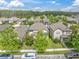 Aerial view of the neighborhood and home with mature landscaping and driveway at 3757 Villamore Ln, Odessa, FL 33556