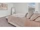 Well-lit bedroom with plush bedding, an accent mirror, and a calming aesthetic at 3757 Villamore Ln, Odessa, FL 33556