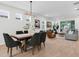 Dining area open to the living room features modern lighting, and wood flooring for seamless entertaining at 3757 Villamore Ln, Odessa, FL 33556