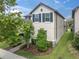 Side view of a two-story home highlighting its architectural design and landscaping at 3757 Villamore Ln, Odessa, FL 33556