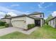 Charming home featuring an attached two-car garage, screened-in porch, and manicured lawn at 3757 Villamore Ln, Odessa, FL 33556