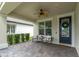 Cozy front porch with comfortable seating and a ceiling fan for outdoor enjoyment at 3757 Villamore Ln, Odessa, FL 33556