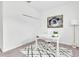 Bright home office with white desk, chair, modern art, closet, and an abstract patterned rug at 3757 Villamore Ln, Odessa, FL 33556