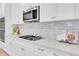 Close-up of a kitchen countertop with a gas stovetop and subway tile backsplash at 3757 Villamore Ln, Odessa, FL 33556