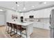 Modern kitchen featuring white cabinetry, quartz countertops, and stainless steel appliances at 3757 Villamore Ln, Odessa, FL 33556