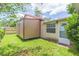 This backyard features a large shed with an entry door to the home at 39055 9Th Ave, Zephyrhills, FL 33542