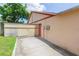Fenced-in backyard with a gate, a storage shed, and a manicured lawn at 39055 9Th Ave, Zephyrhills, FL 33542