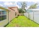 Spacious backyard featuring lush green grass and a white fence line at 39055 9Th Ave, Zephyrhills, FL 33542