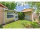 Backyard of the home featuring a door and a partially covered entry at 39055 9Th Ave, Zephyrhills, FL 33542