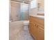 Bathroom with tiled shower, vanity with granite countertop and tile flooring at 39055 9Th Ave, Zephyrhills, FL 33542