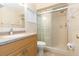 Bright bathroom with tiled shower, vanity with granite countertop and tile flooring at 39055 9Th Ave, Zephyrhills, FL 33542