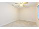 Bedroom with ceiling fan, neutral walls, tile flooring, and window at 39055 9Th Ave, Zephyrhills, FL 33542