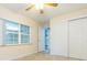 Bedroom with closet, ceiling fan, tile flooring, and window at 39055 9Th Ave, Zephyrhills, FL 33542