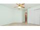 Bedroom featuring tile flooring, ceiling fan and closet at 39055 9Th Ave, Zephyrhills, FL 33542