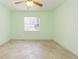 Bedroom features neutral color palette, tile flooring, and window at 39055 9Th Ave, Zephyrhills, FL 33542