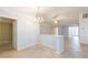 Open dining area featuring tile flooring, a chandelier and access to living spaces at 39055 9Th Ave, Zephyrhills, FL 33542