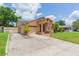Well-kept single-story home with a driveway, garage and landscaped lawn at 39055 9Th Ave, Zephyrhills, FL 33542