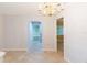 Hallway features neutral color palette, tile flooring, and access to other rooms at 39055 9Th Ave, Zephyrhills, FL 33542